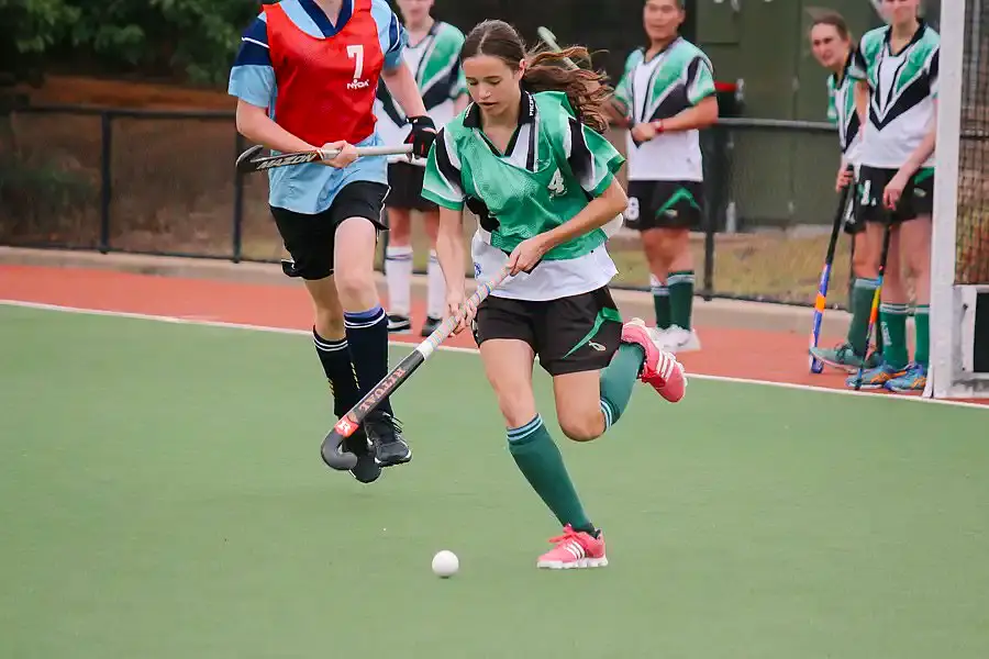 Student in sports uniform playing cricket
